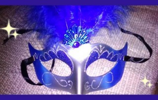 Blue and silver masks with large feathers on top