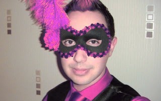 Teenage guy wearing a black and purple mask